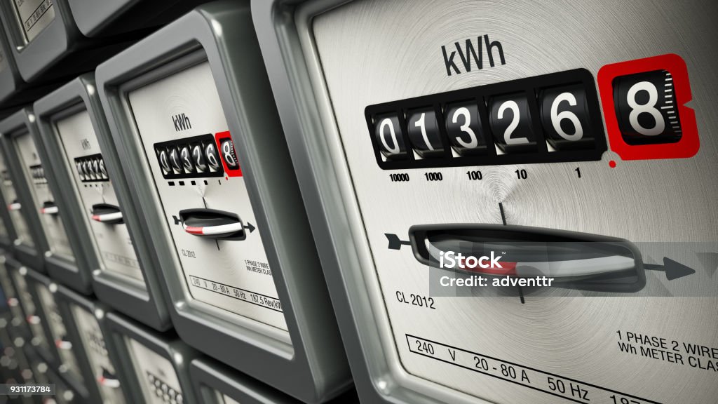 Electric meters in a row standing on the wall.